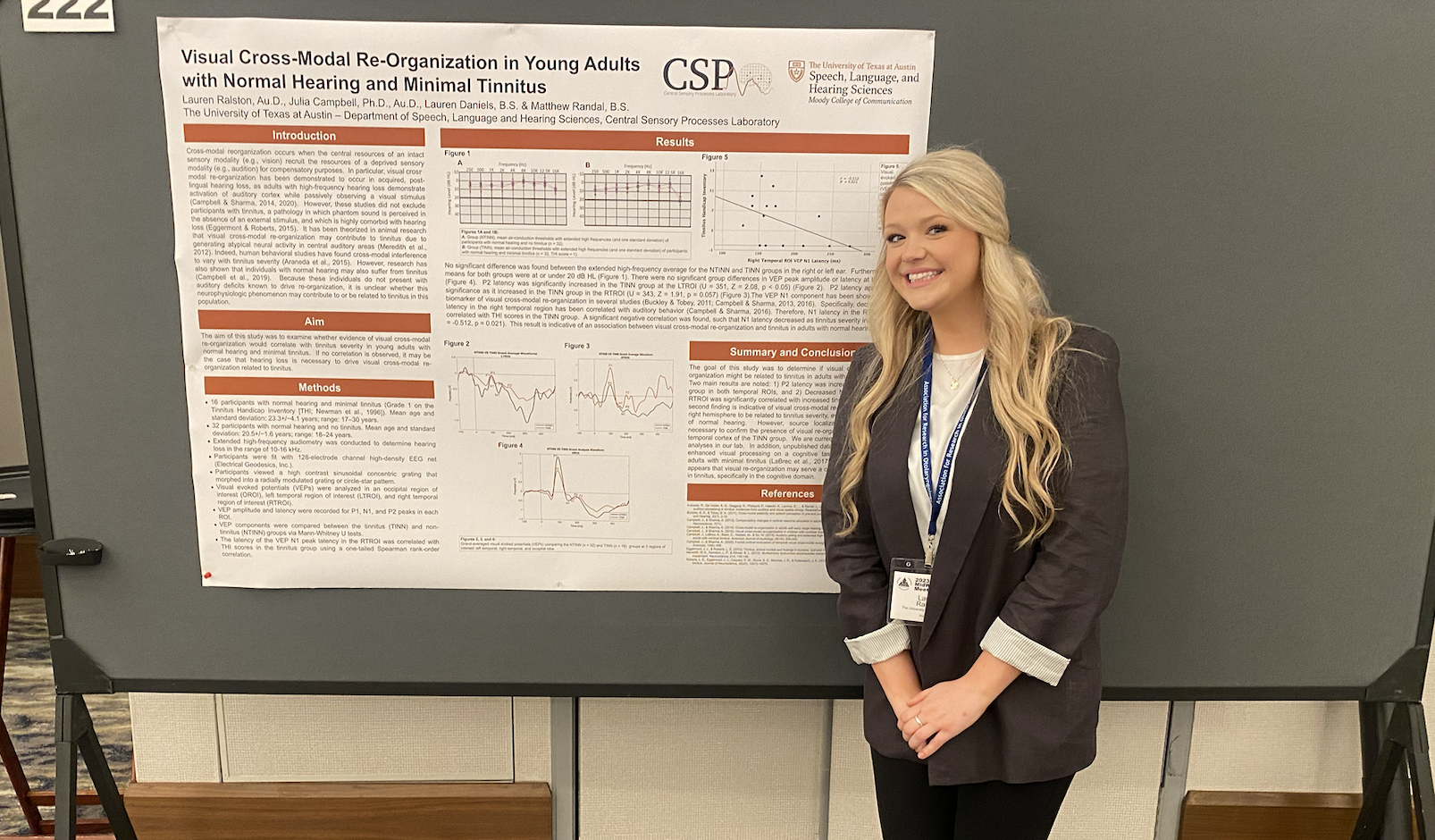 photo of Lauren in front of her research poster 