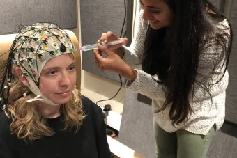Graduate student Maansi Desai piloting an EEG study with Dr. Liberty Hamilton
