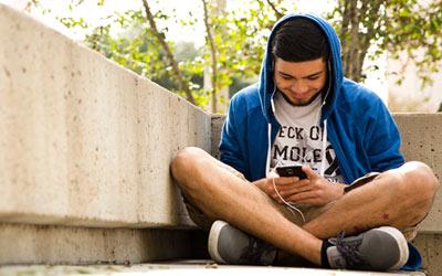 Student sitting outside of Moody College