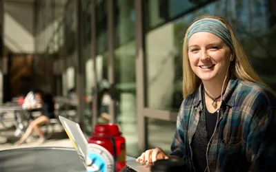 Student sitting outside of Moody College