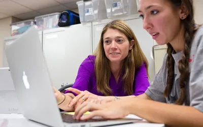 Students collaborating at a computer