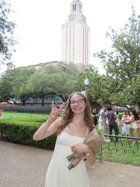 Picture of Harley wearing a yellow dress holding flowers. 