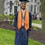 Full body picture of Jacob Leisawitz in graduation robes.